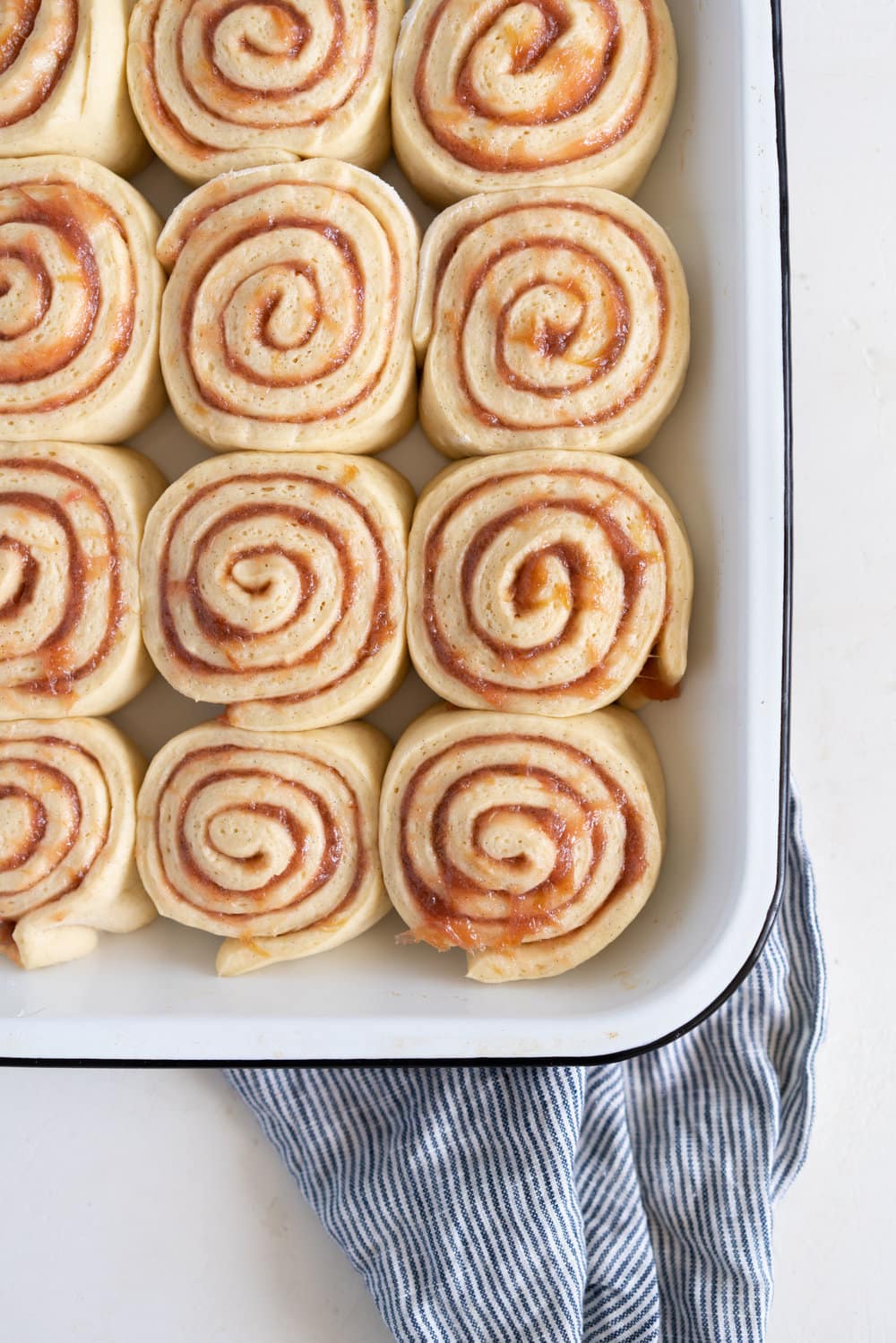 Rhubarb Sticky Buns - Brioche Spiked with vanilla, filled with rhubarb quick jam, and finished with a vanilla bean mascarpone frosting. #stickybuns #rhubarb #vanillabean #cloudykitchen