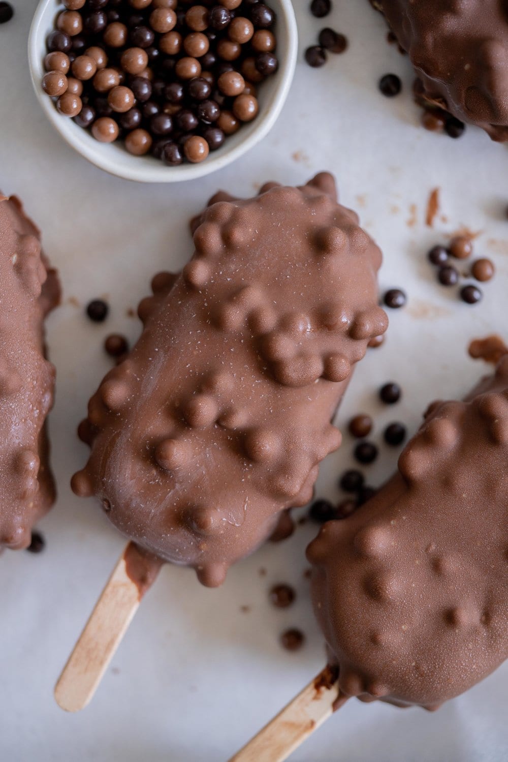Rocky Road Ice Cream Pops by Cloudy Kitchen. Rich Chocolate ice cream is studded with marshmallow and turkish delight pieces, frozen into a pop, then dipped in creamy milk chocolate with crispy pearls. #Rockyroad #icecreampop #popsicle #cloudykitchen