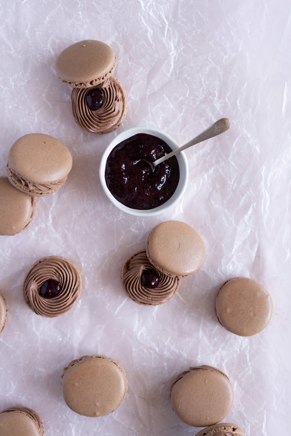 Black Forest inspired Macarons - chocolate macarons with Dark Chocolate Swiss Meringue Buttercream and Cherry Compote Filling. #Chocolate #Macaron #Blackforest #cherry #compote #Frenchmacaron