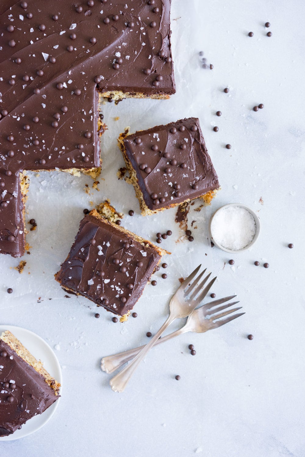 Banana Sheet Cake with Whipped Dark Chocolate Ganache. A little bit fancy but perfect for a crowd, this banana sheet cake will be your secret dessert weapon! #bananacake #sheetcake #chocolateganache #chocolatefrosting