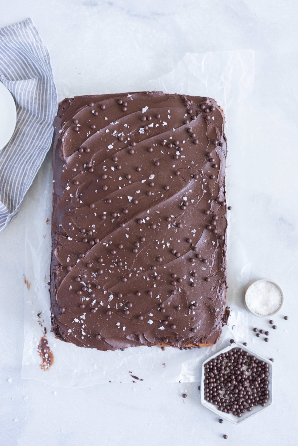 Banana Sheet Cake with Whipped Dark Chocolate Ganache. A little bit fancy but perfect for a crowd, this banana sheet cake will be your secret dessert weapon! #bananacake #sheetcake #chocolateganache #chocolatefrosting