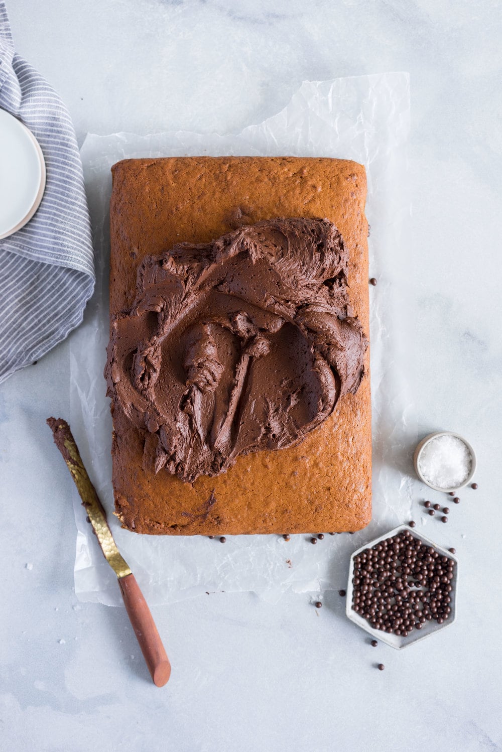 Banana Sheet Cake with Whipped Dark Chocolate Ganache. A little bit fancy but perfect for a crowd, this banana sheet cake will be your secret dessert weapon! #bananacake #sheetcake #chocolateganache #chocolatefrosting