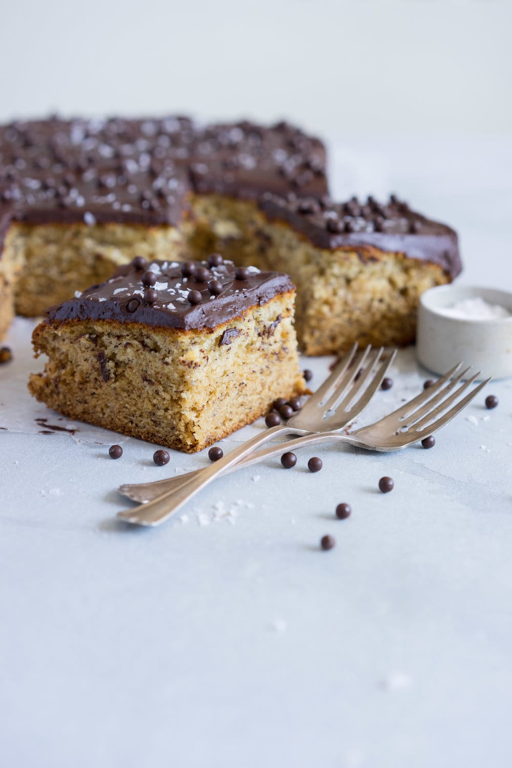 Banana Sheet Cake with Whipped Dark Chocolate Ganache. A little bit fancy but perfect for a crowd, this banana sheet cake will be your secret dessert weapon! #bananacake #sheetcake #chocolateganache #chocolatefrosting
