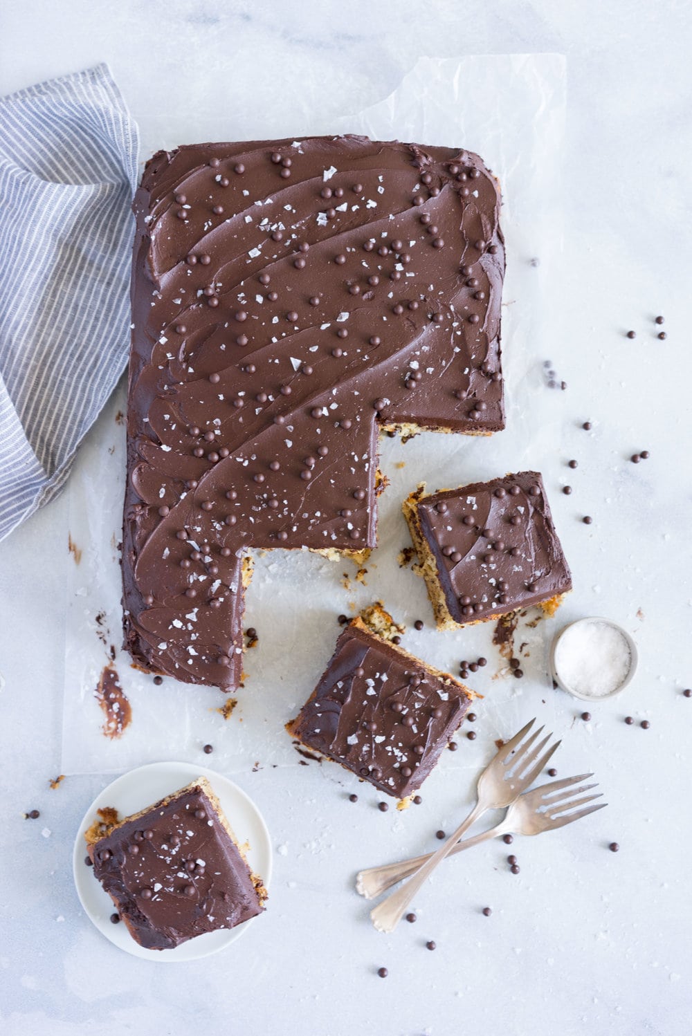 Banana Sheet Cake with Whipped Dark Chocolate Ganache. A little bit fancy but perfect for a crowd, this banana sheet cake will be your secret dessert weapon! #bananacake #sheetcake #chocolateganache #chocolatefrosting