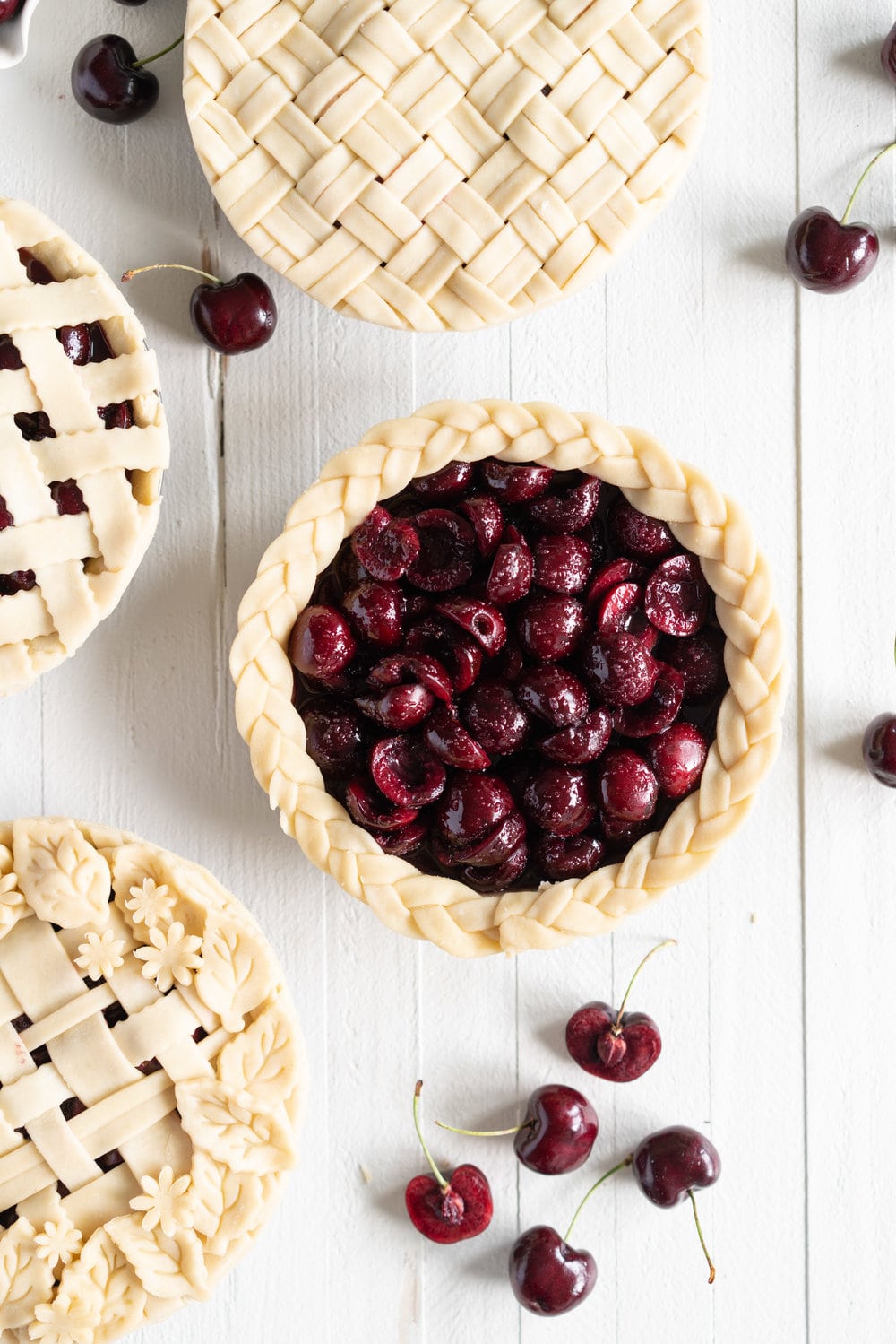When you have beautiful, in season cherries, it really is a shame to do anything with it other than make Cherry Pie! These cherry pies are perfectly juicy, with the right balance of sweetness, and have a tender, flaky crust. They are easy to make, can be prepared ahead, and make the perfect summer dessert. #pie #cherrypie #recipe #darkcherrypie #fruitpie