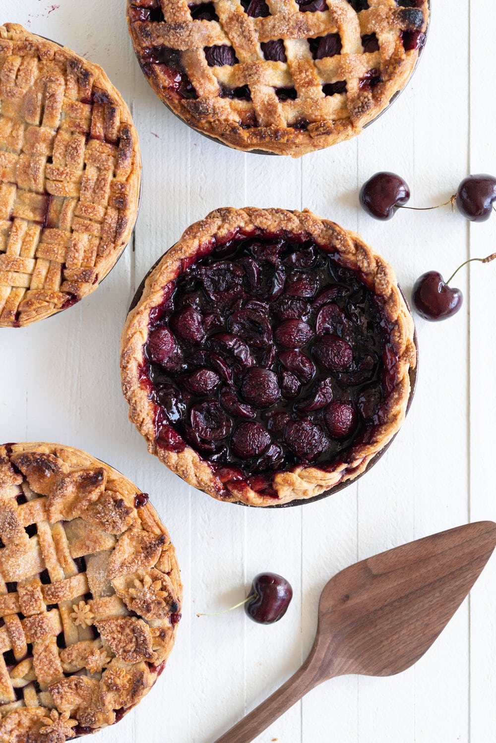When you have beautiful, in season cherries, it really is a shame to do anything with it other than make Cherry Pie! These cherry pies are perfectly juicy, with the right balance of sweetness, and have a tender, flaky crust. They are easy to make, can be prepared ahead, and make the perfect summer dessert. #pie #cherrypie #recipe #darkcherrypie #fruitpie