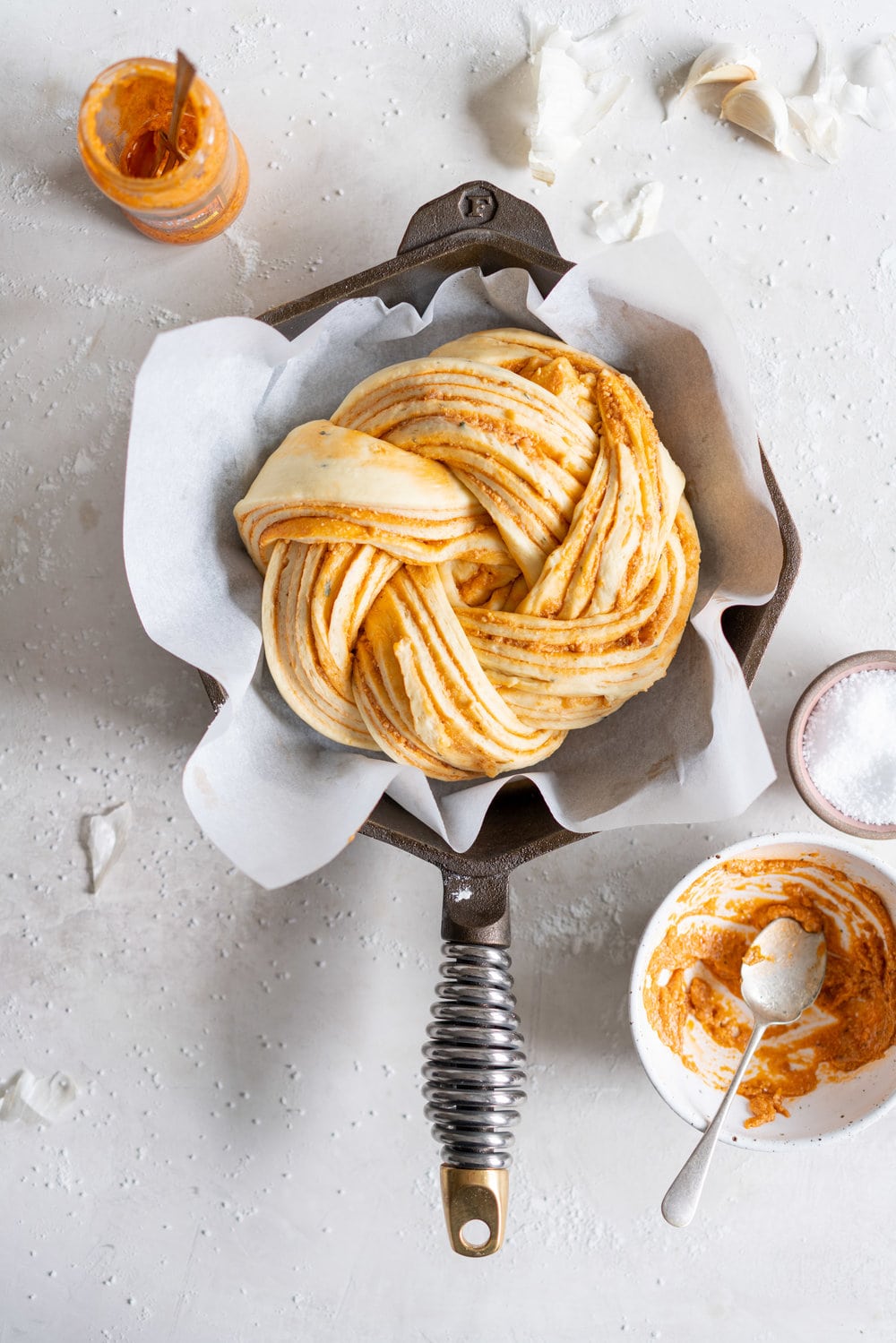 Fluffy Brioche filled with Roasted Garlic, Tomato and Ricotta Pesto. Rolled up and twisted into a knot, and baked to golden, puffy perfection. Perfect on it's own or as an addition to a lunch or alongside a bowl of soup. #brioche #briocheknot #pestobrioche
