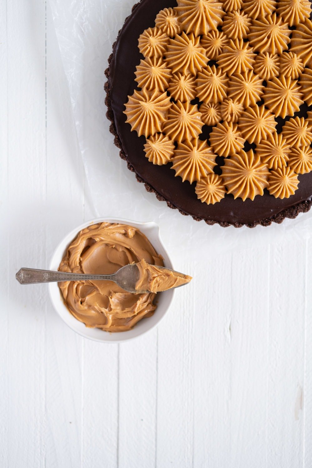 Dark Chocolate Peanut Butter Tart with Peanut Butter Whipped Cream - a chocolate graham cracker crust is topped with a silky dark chocolate peanut butter filling and finished with a creamy peanut butter whipped cream. Everyone needs a recipe like this up their sleeve to wow their friends. Easy to make ahead, and always a crowd pleaser. #chocolatetart #peanutbuttertart #chocolate #peanutbutter