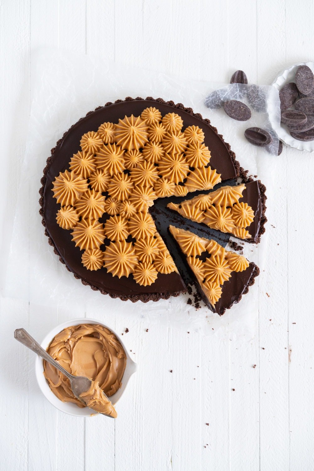 Dark Chocolate Peanut Butter Tart with Peanut Butter Whipped Cream - a chocolate graham cracker crust is topped with a silky dark chocolate peanut butter filling and finished with a creamy peanut butter whipped cream. Everyone needs a recipe like this up their sleeve to wow their friends. Easy to make ahead, and always a crowd pleaser. #chocolatetart #peanutbuttertart #chocolate #peanutbutter