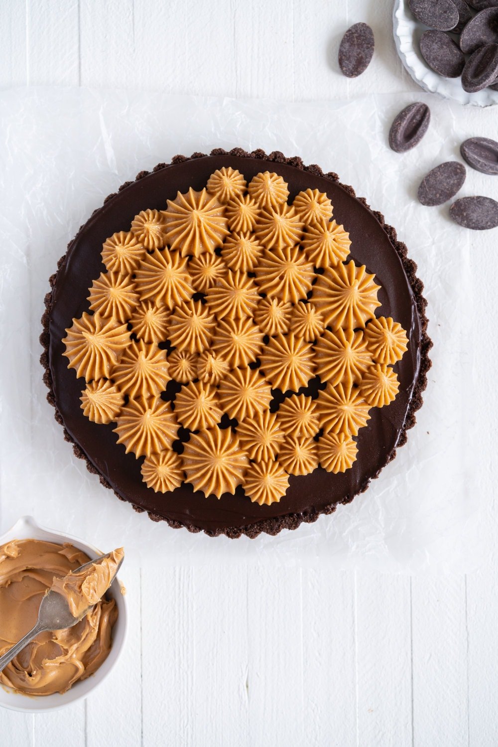 Dark Chocolate Peanut Butter Tart with Peanut Butter Whipped Cream - a chocolate graham cracker crust is topped with a silky dark chocolate peanut butter filling and finished with a creamy peanut butter whipped cream. Everyone needs a recipe like this up their sleeve to wow their friends. Easy to make ahead, and always a crowd pleaser. #chocolatetart #peanutbuttertart #chocolate #peanutbutter