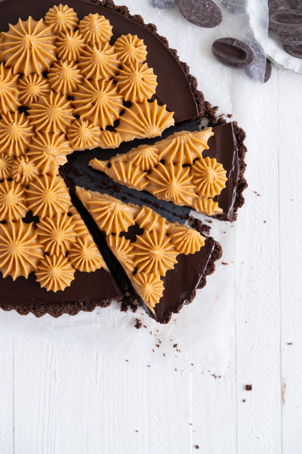 Dark Chocolate Peanut Butter Tart with Peanut Butter Whipped Cream - a chocolate graham cracker crust is topped with a silky dark chocolate peanut butter filling and finished with a creamy peanut butter whipped cream. Everyone needs a recipe like this up their sleeve to wow their friends. Easy to make ahead, and always a crowd pleaser. #chocolatetart #peanutbuttertart #chocolate #peanutbutter