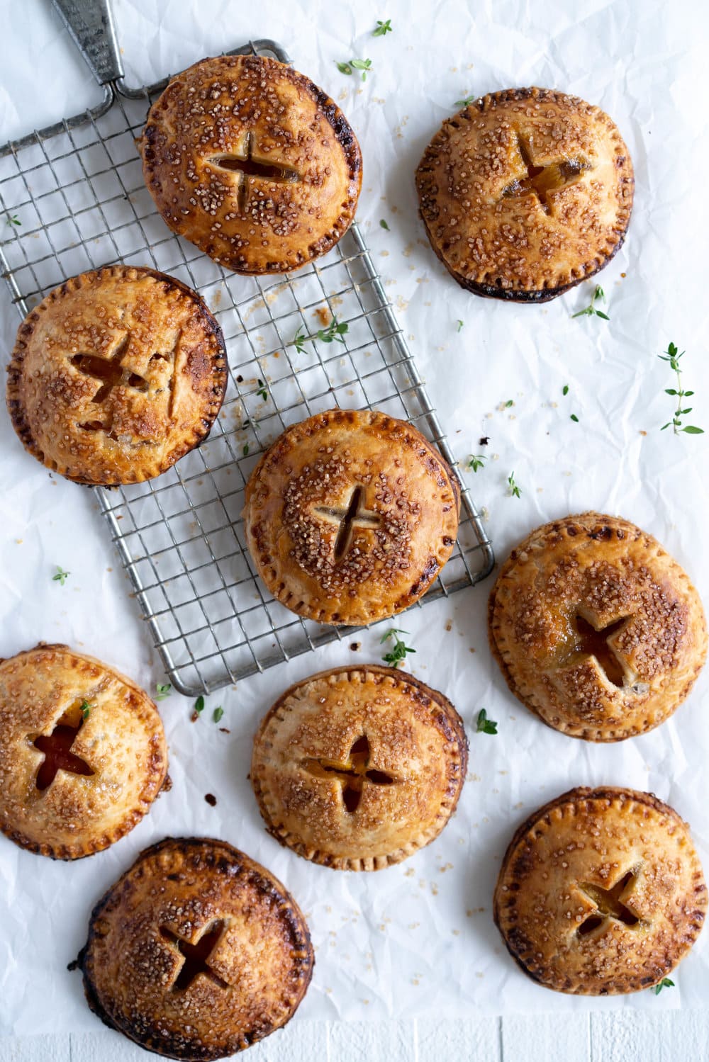 Peach and Thyme Hand pies - sweet, ripe peaches are enveloped in a tender flaky pie crust, and enhanced with the delicate flavour of thyme. #handpies #peachpies #pie #baking #peach #thyme