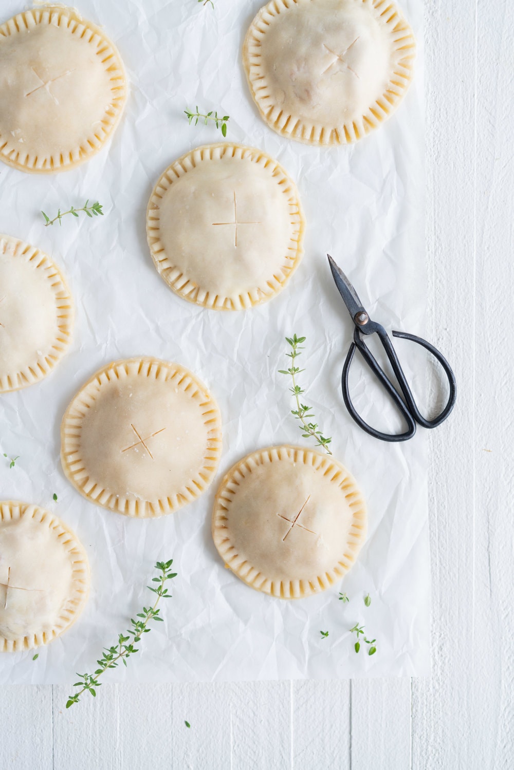 Peach and Thyme Hand pies - sweet, ripe peaches are enveloped in a tender flaky pie crust, and enhanced with the delicate flavour of thyme. #handpies #peachpies #pie #baking #peach #thyme