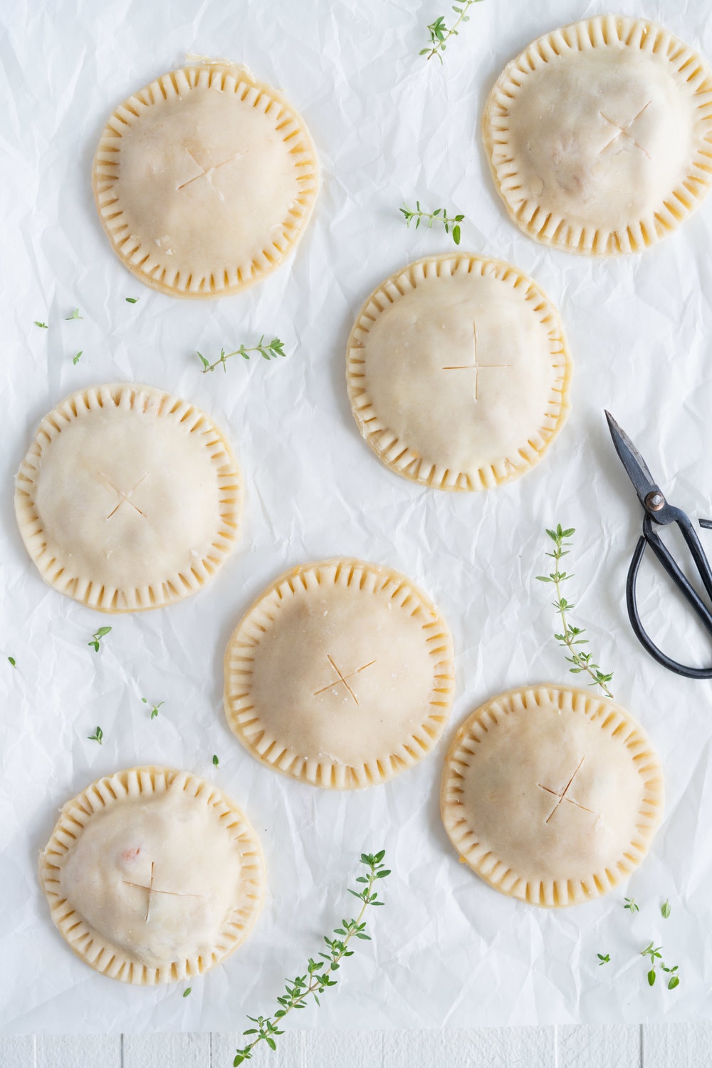 Peach and Thyme Hand pies - sweet, ripe peaches are enveloped in a tender flaky pie crust, and enhanced with the delicate flavour of thyme. #handpies #peachpies #pie #baking #peach #thyme