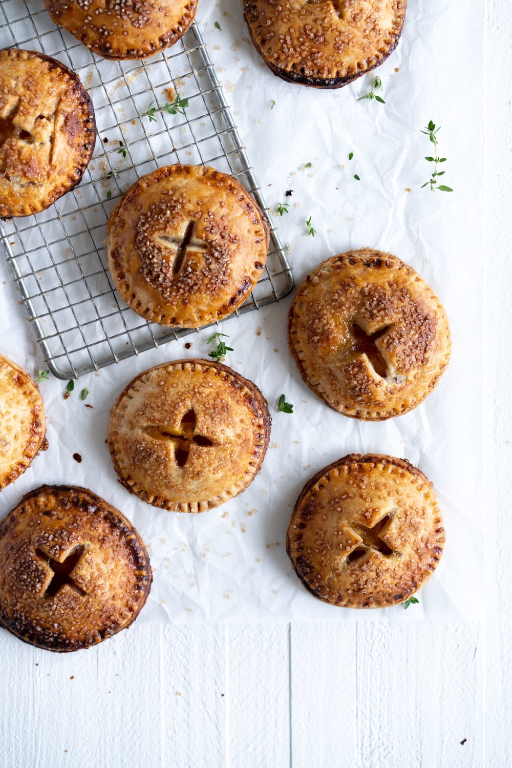 Peach and Thyme Hand pies - sweet, ripe peaches are enveloped in a tender flaky pie crust, and enhanced with the delicate flavour of thyme. #handpies #peachpies #pie #baking #peach #thyme