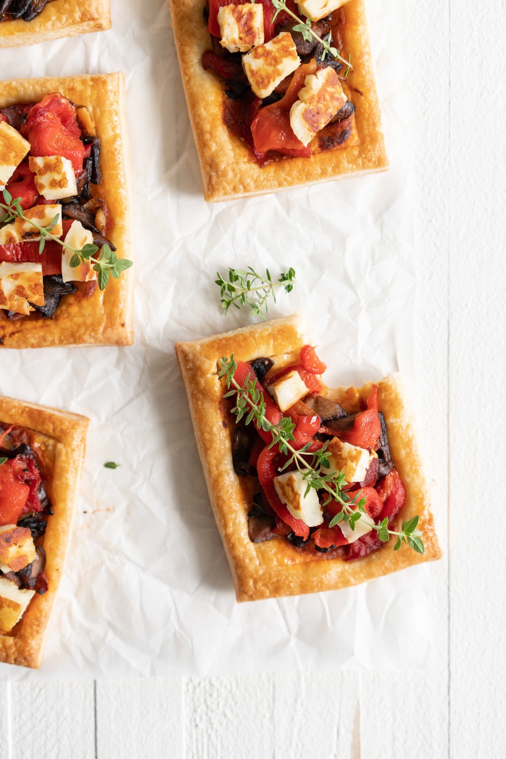 Chili Pesto, Mushroom, Roasted Red Pepper and Halloumi Tarts with Homemade Puff Pastry. The perfect appetizer or summer dinner - make these whatever size you want, they are bound to be a crowd pleaser! #mushroomtart #halloumi #chili #chilli #pesto #puffpastry #tart