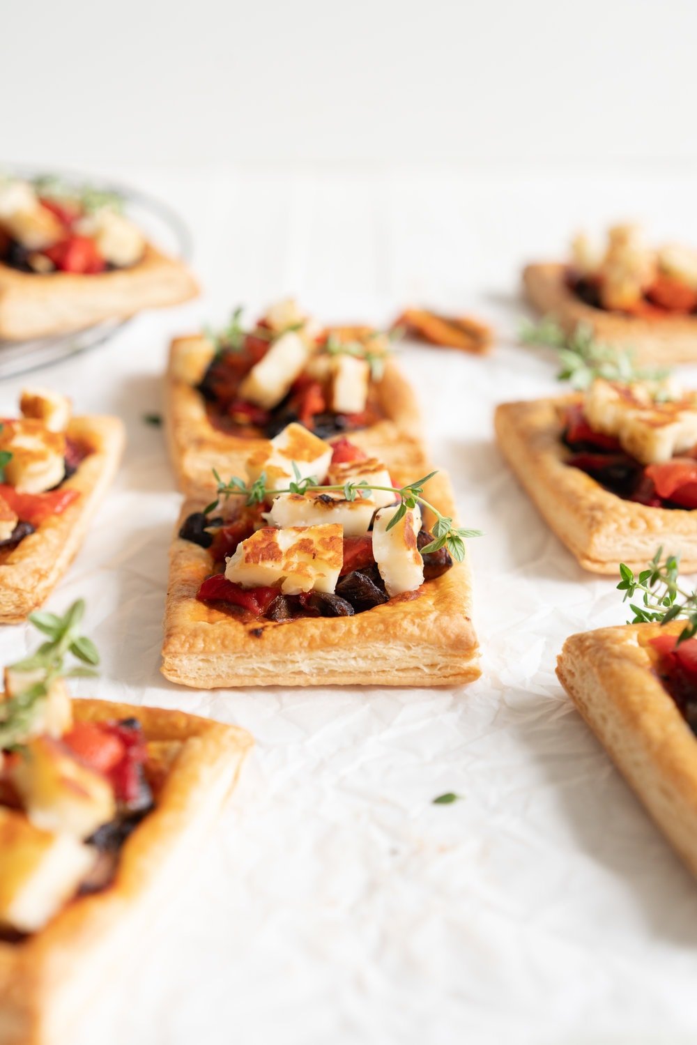 Chili Pesto, Mushroom, Roasted Red Pepper and Halloumi Tarts with Homemade Puff Pastry. The perfect appetizer or summer dinner - make these whatever size you want, they are bound to be a crowd pleaser! #mushroomtart #halloumi #chili #chilli #pesto #puffpastry #tart
