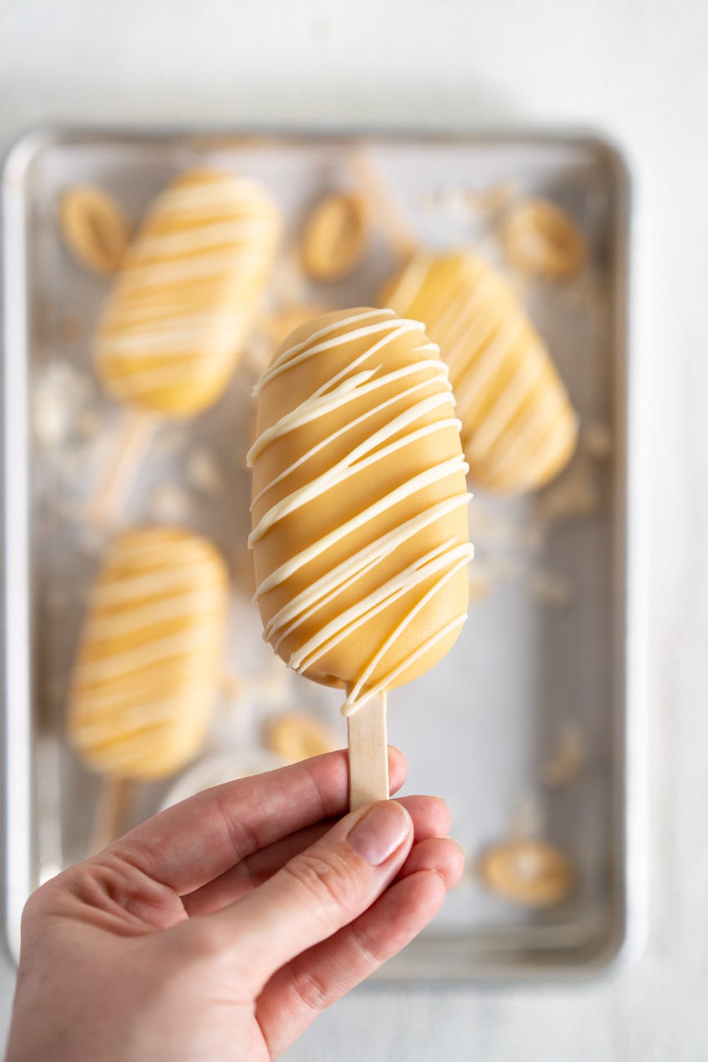 Toasted Coconut Ice Cream Pops with Passionfruit magic shell - a creamy toasted coconut ice cream is dipped in a punchy passionfruit magic shell. Quite possibly the most perfect ice cream combination you will ever come across. #passionfruit #toastedcoconut #icecreampop #icecream #magicshell