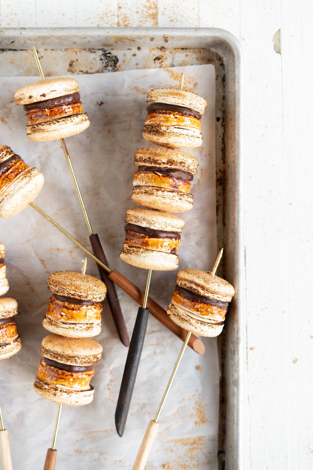 skewers with macarons on a sheet pan with parchment paper