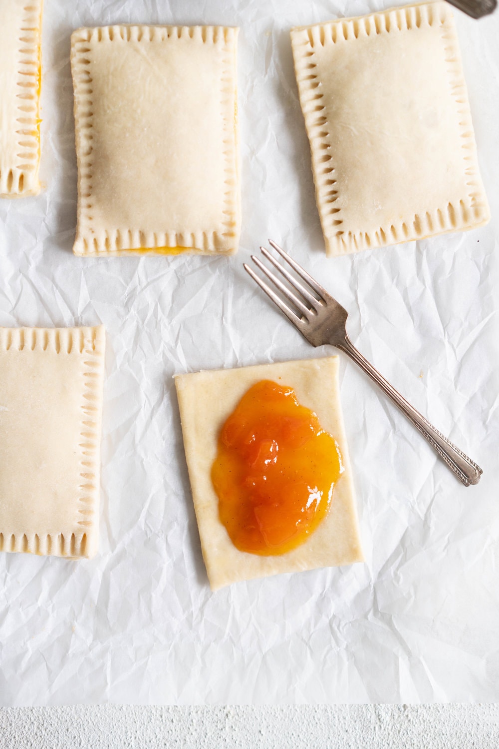 Apricot Pop Tarts with Vanilla Bean Icing - a quick apricot jam is enclosed in a buttery, flaky puff pastry, before being finished off with a vanilla bean icing. #poptart #pastry #apricot #jam #apricotjam #vanillabean
