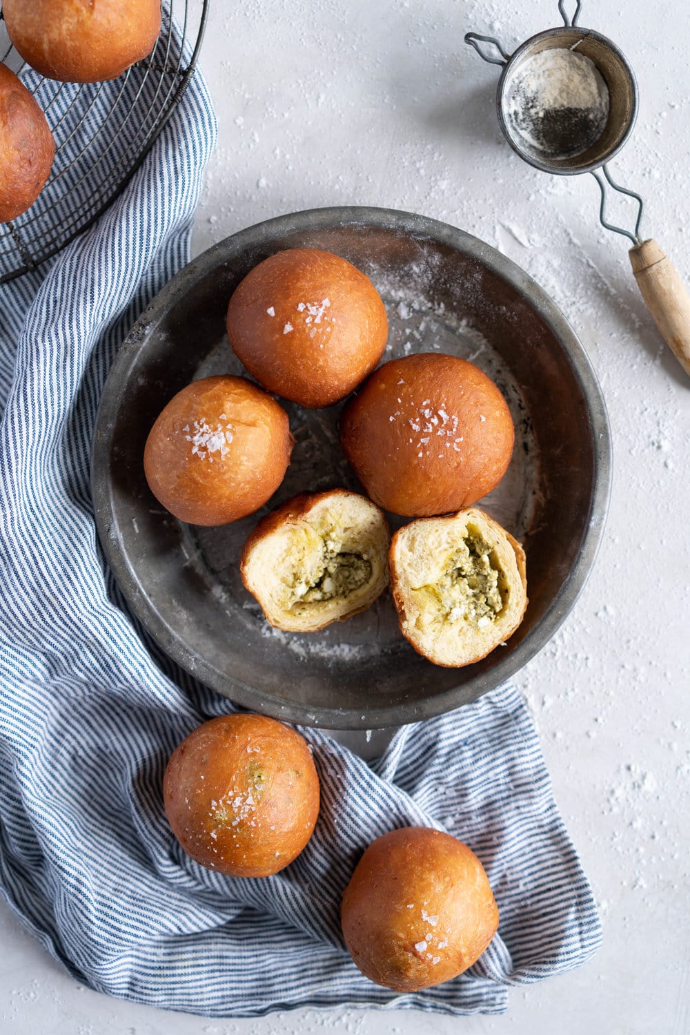 Basil Pesto and Feta Stuffed Savoury Brioche Doughnuts - Brioche dough is wrapped around a basil pesto and feta filling, then fried to golden brown perfection #savoury #savory #briochedoughnut #pestoandfeta #donut #brioche