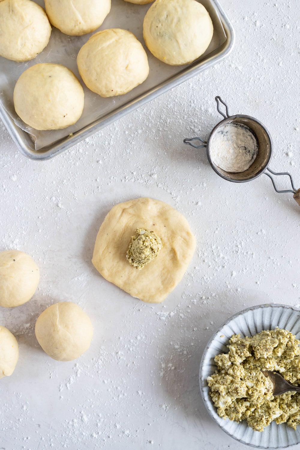 Basil Pesto and Feta Stuffed Savoury Brioche Doughnuts - Brioche dough is wrapped around a basil pesto and feta filling, then fried to golden brown perfection #savoury #savory #briochedoughnut #pestoandfeta #donut #brioche