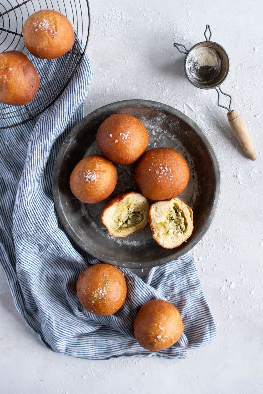 Basil Pesto and Feta Stuffed Savoury Brioche Doughnuts - Brioche dough is wrapped around a basil pesto and feta filling, then fried to golden brown perfection #savoury #savory #briochedoughnut #pestoandfeta #donut #brioche