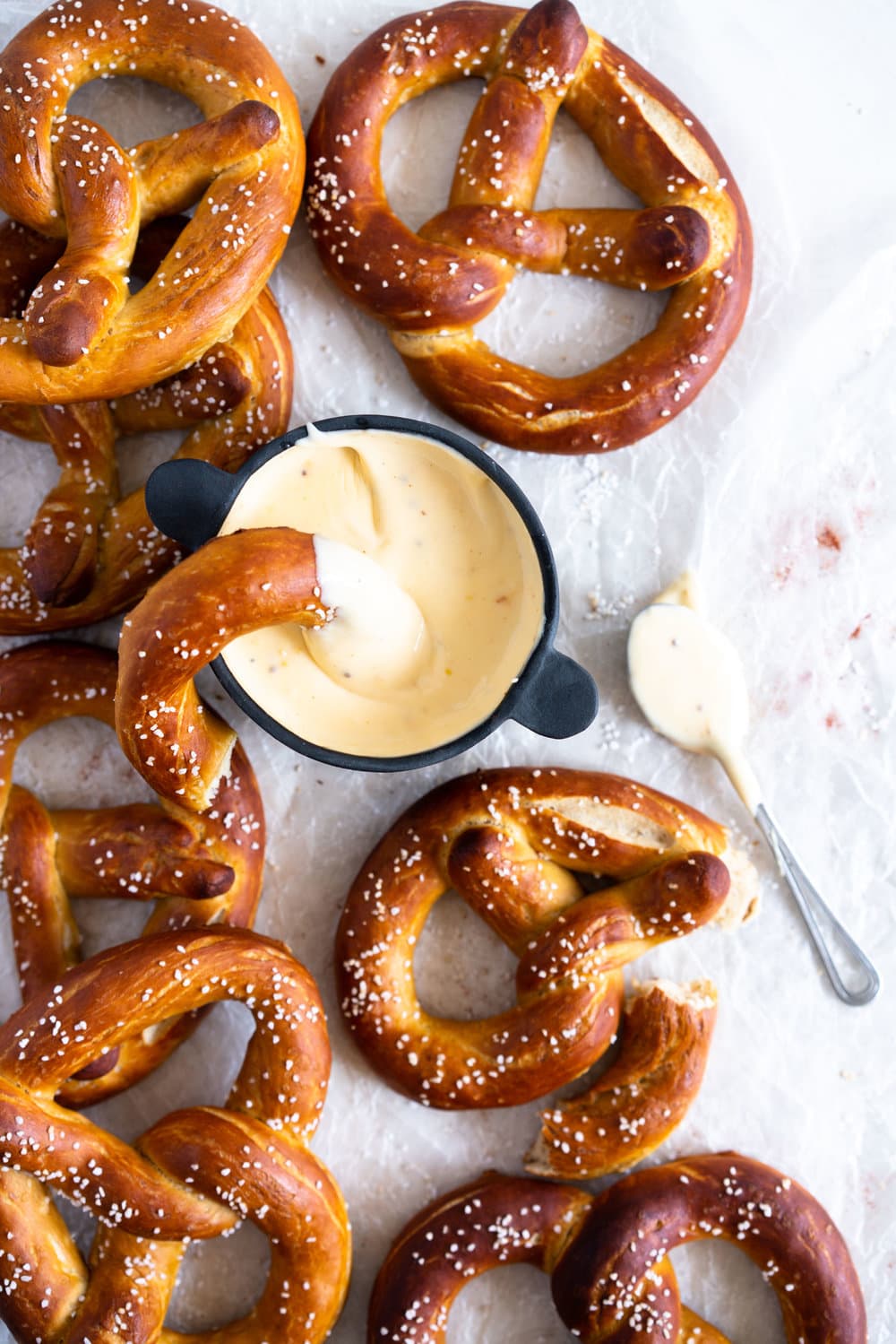 pretzels on wax paper with cheese sauce