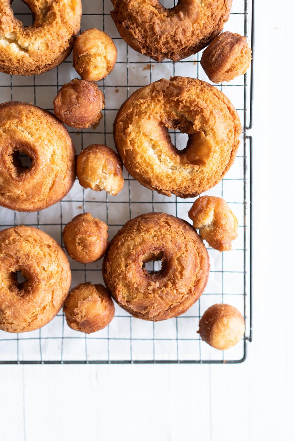 Vanilla Bean Old Fashioned Doughnuts - made as a cake doughnut rather than it's friend the yeast raised doughnut, old fashioned doughnuts are cakey and dense, fried to golden perfection, and then finished with a vanilla bean glaze. #oldfashioned #doughnuts #cakedoughnuts #cakedonut #vanillabean #staub