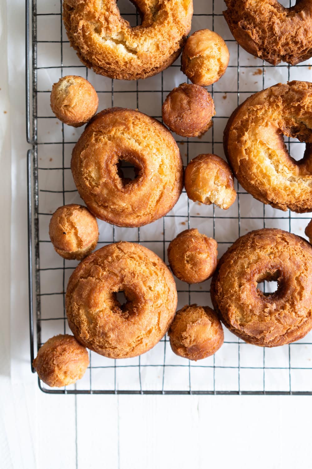 Vanilla Bean Old Fashioned Doughnuts - made as a cake doughnut rather than it's friend the yeast raised doughnut, old fashioned doughnuts are cakey and dense, fried to golden perfection, and then finished with a vanilla bean glaze. #oldfashioned #doughnuts #cakedoughnuts #cakedonut #vanillabean #staub