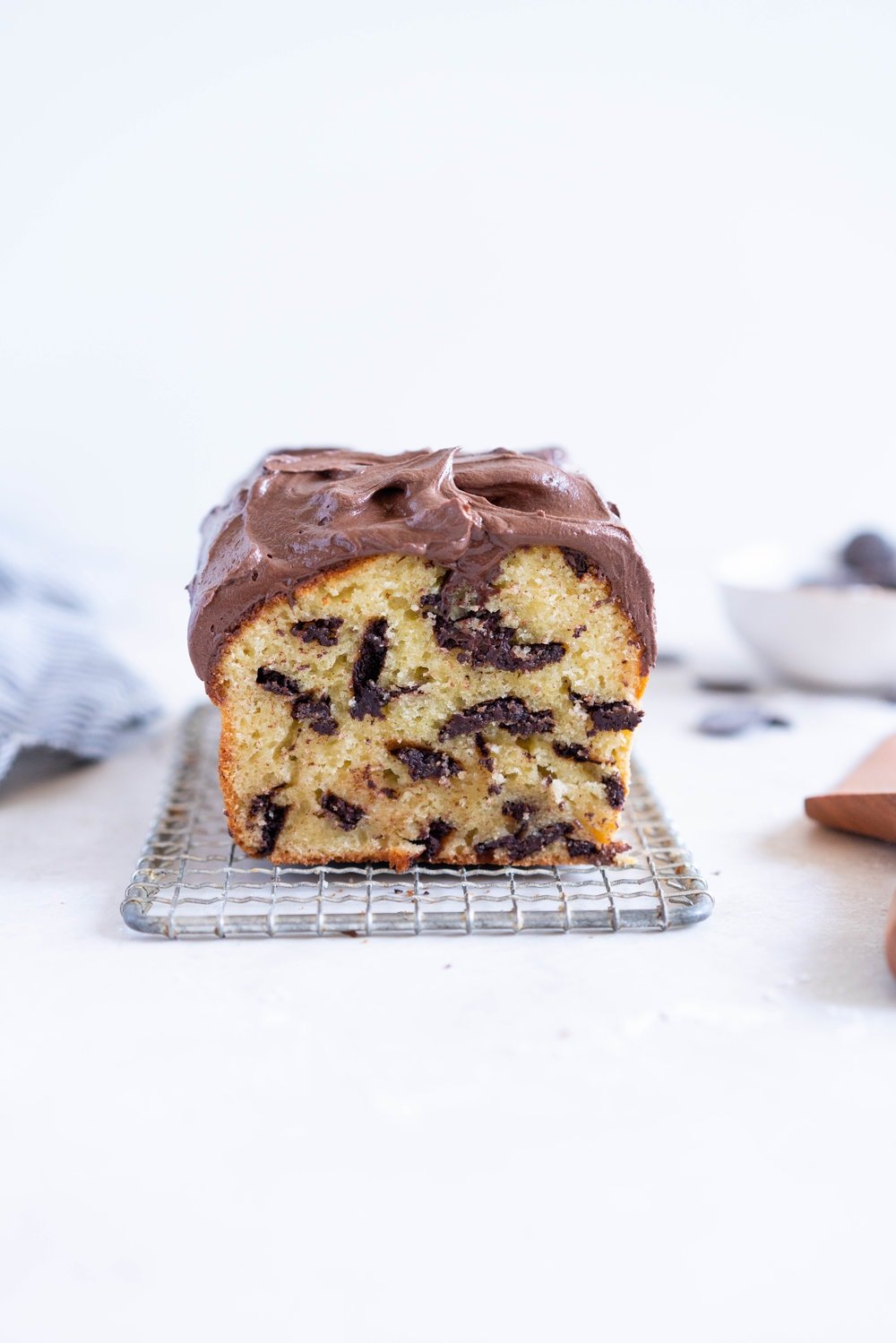 Chocolate Chunk Olive Oil Ricotta cake with Dark Chocolate buttercream - this cake is flavoursome from the olive oil, with a perfect crumb from the ricotta in the batter. It is studded with dark chocolate chunks throughout, and finished with a silky smooth dark chocolate buttercream. The perfect elevated loaf cake. #loafcake #poundcake #ricottacake