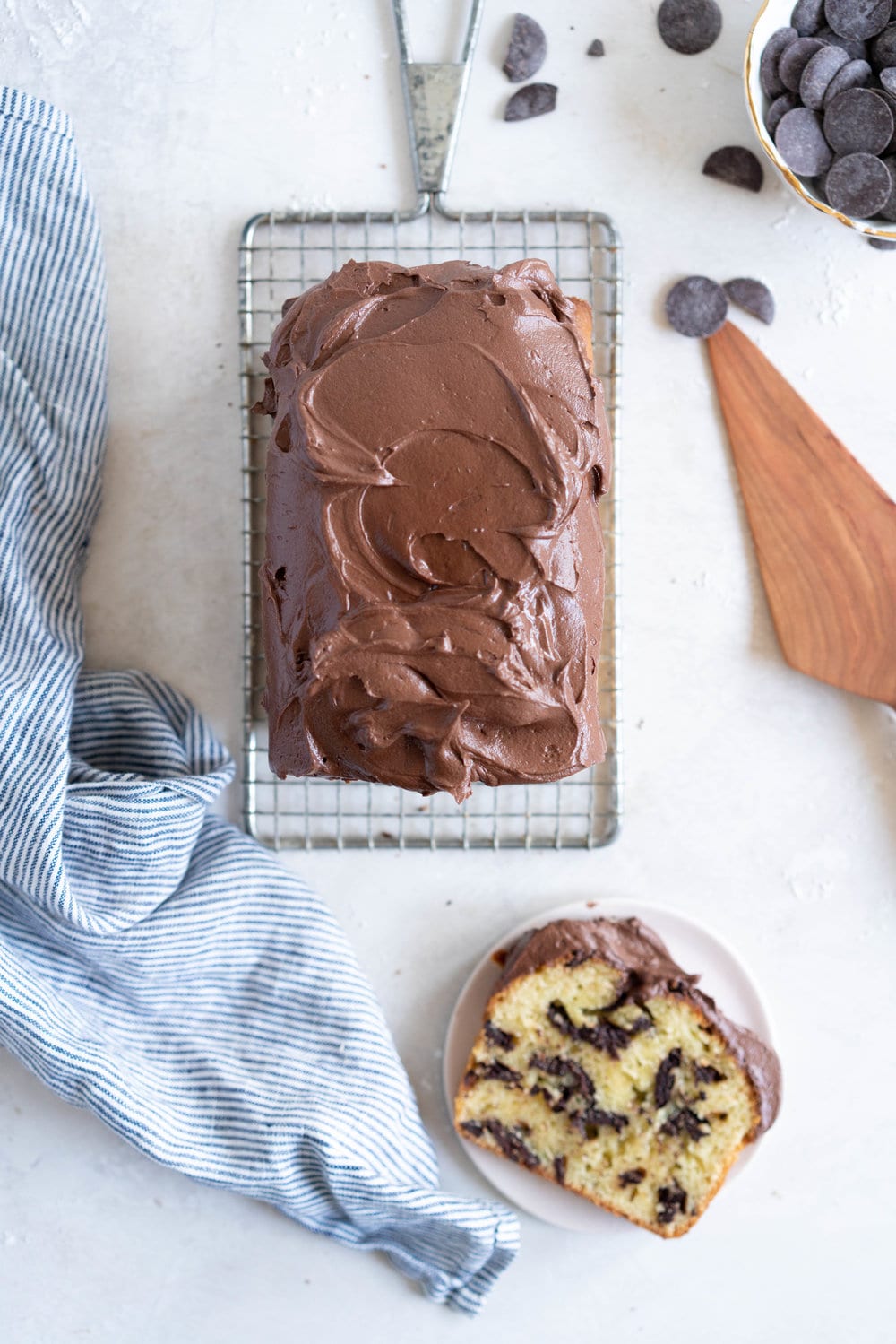 Chocolate Chunk Olive Oil Ricotta cake with Dark Chocolate buttercream - this cake is flavoursome from the olive oil, with a perfect crumb from the ricotta in the batter. It is studded with dark chocolate chunks throughout, and finished with a silky smooth dark chocolate buttercream. The perfect elevated loaf cake. #loafcake #poundcake #ricottacake