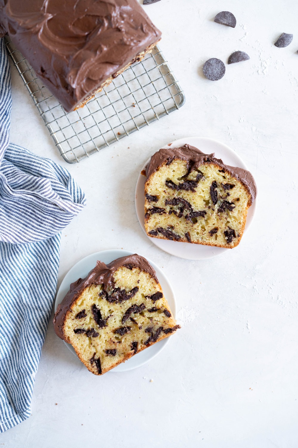 Chocolate Chunk Olive Oil Ricotta cake with Dark Chocolate buttercream - this cake is flavoursome from the olive oil, with a perfect crumb from the ricotta in the batter. It is studded with dark chocolate chunks throughout, and finished with a silky smooth dark chocolate buttercream. The perfect elevated loaf cake. #loafcake #poundcake #ricottacake