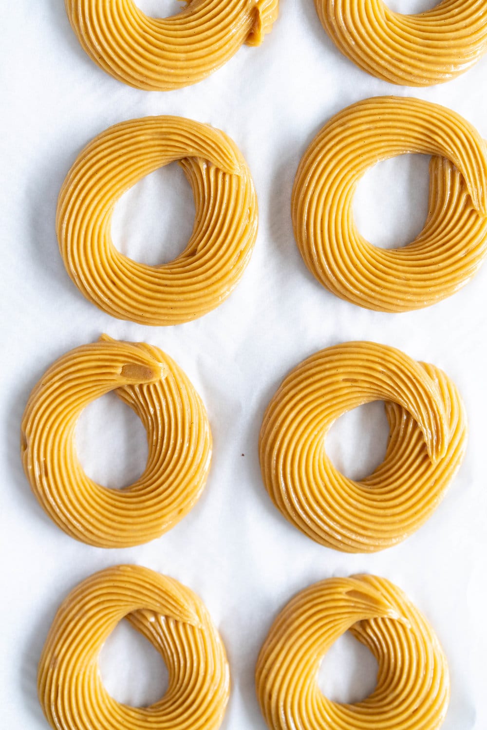 Earl Grey Crullers with Earl Grey Glaze. Perfectly flaky earl grey infused choux pastry is fried into golden brown crullers, then glazed with a delicately flavoured Earl Grey Glaze. #earlgrey #cruller #doughnuts #donuts #baking #fried #choux #chouxpastry