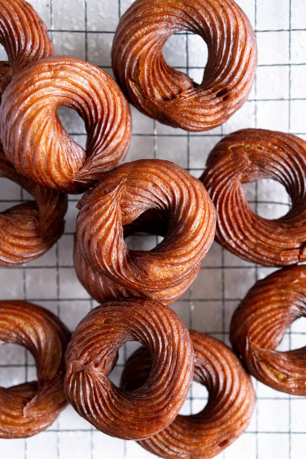 Earl Grey Crullers with Earl Grey Glaze. Perfectly flaky earl grey infused choux pastry is fried into golden brown crullers, then glazed with a delicately flavoured Earl Grey Glaze. #earlgrey #cruller #doughnuts #donuts #baking #fried #choux #chouxpastry