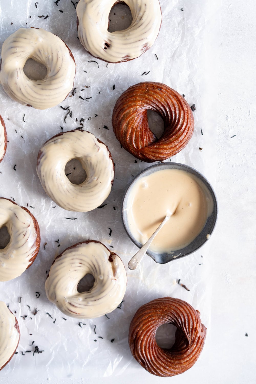 Earl Grey Crullers with Earl Grey Glaze. Perfectly flaky earl grey infused choux pastry is fried into golden brown crullers, then glazed with a delicately flavoured Earl Grey Glaze. #earlgrey #cruller #doughnuts #donuts #baking #fried #choux #chouxpastry