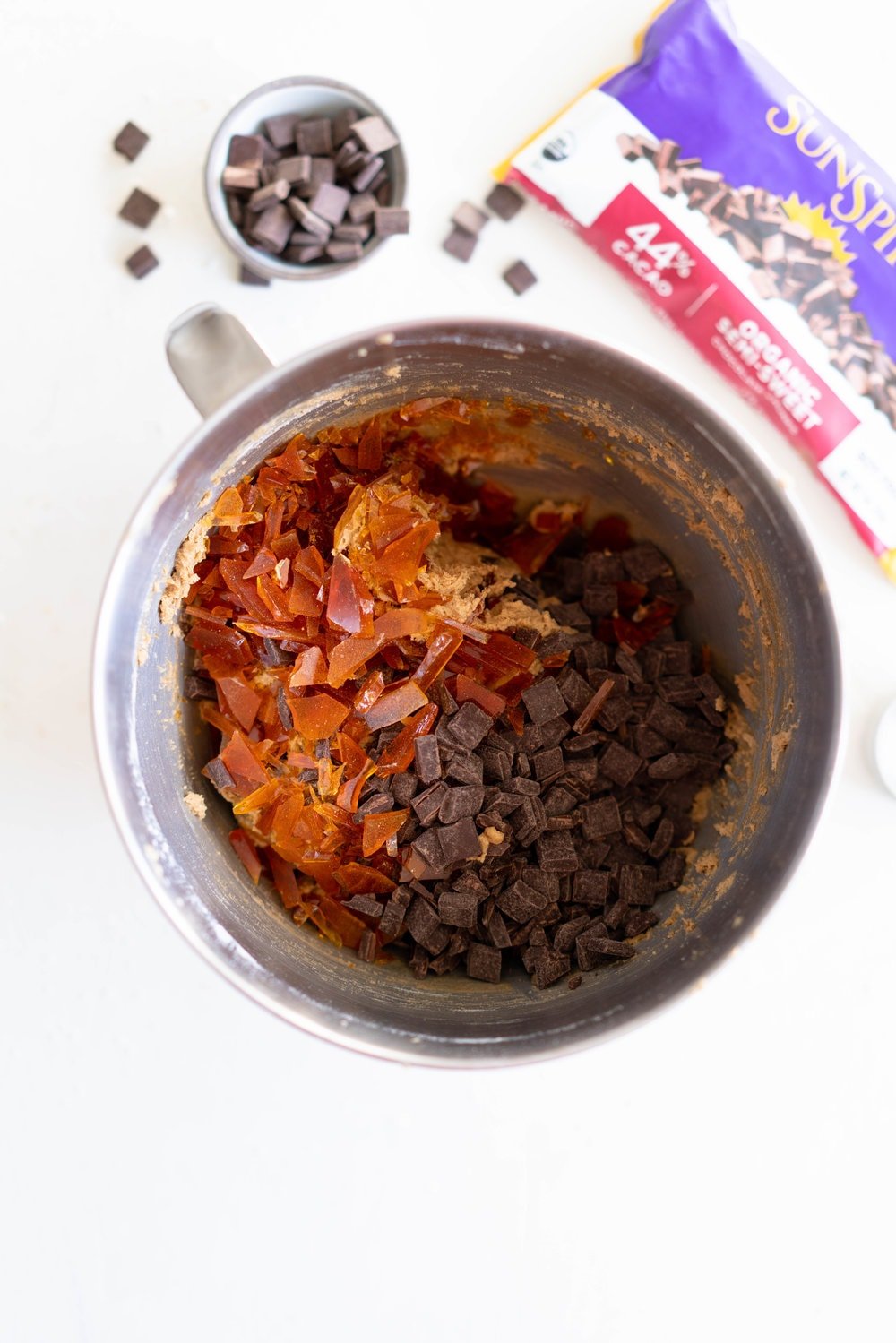 Brown Butter Salted Caramel Chocolate Chunk Cookies. Regular pantry staples are elevated to another level to give this cookie a 'fancy with only a little more effort' vibe. Brown butter is stirred in with toasty muscovado sugar to form a perfect cookie dough, and then hard caramel shards and chocolate chunks are folded in to give the perfect amount of chocolate and caramel per bite. Finished with flaky sea salt, this is a super easy yet satisfying baking recipe. #saltedcaramelcookie #chocolatechunkcookie #brownbutter