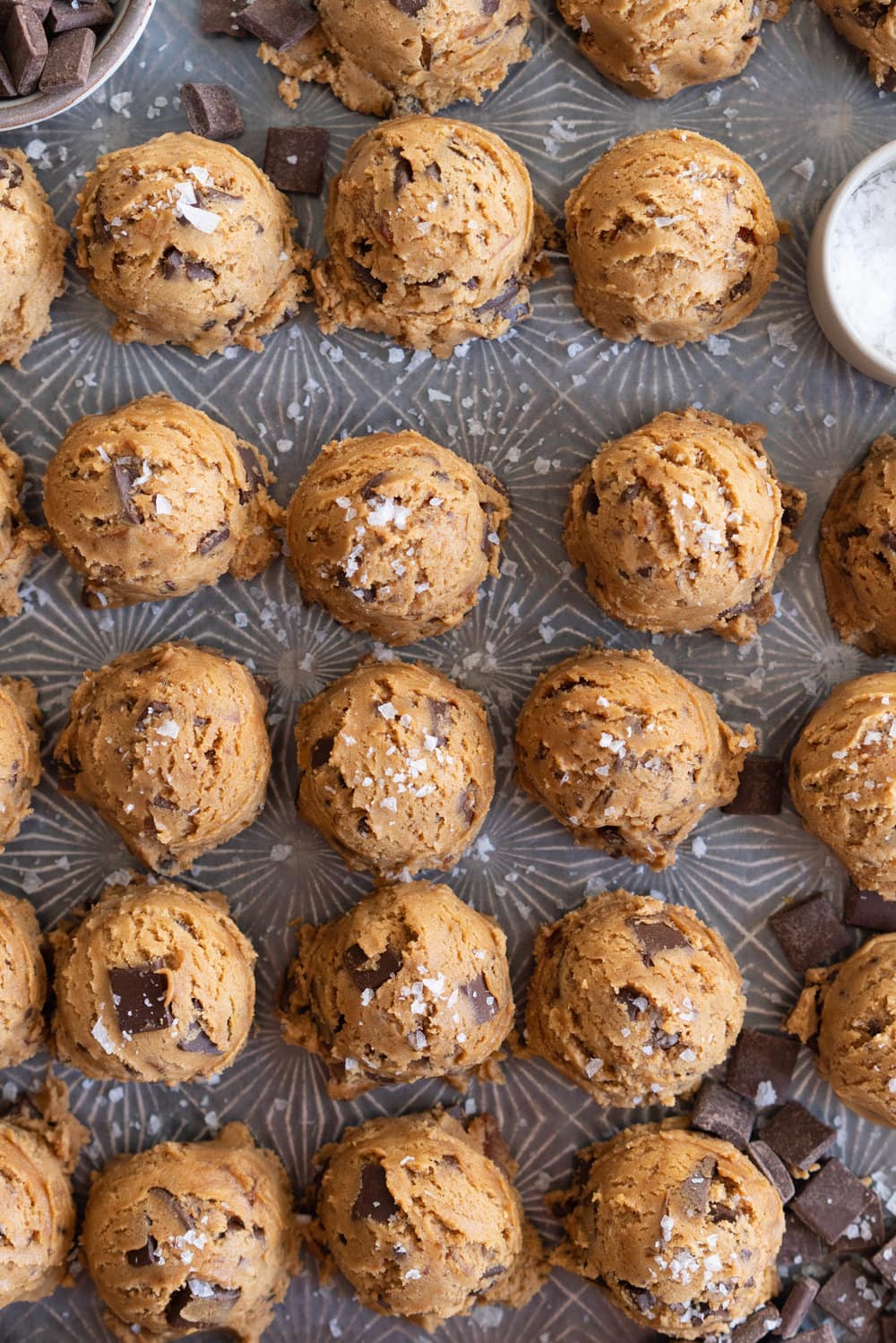 Brown Butter Salted Caramel Chocolate Chunk Cookies. Regular pantry staples are elevated to another level to give this cookie a 'fancy with only a little more effort' vibe. Brown butter is stirred in with toasty muscovado sugar to form a perfect cookie dough, and then hard caramel shards and chocolate chunks are folded in to give the perfect amount of chocolate and caramel per bite. Finished with flaky sea salt, this is a super easy yet satisfying baking recipe. #saltedcaramelcookie #chocolatechunkcookie #brownbutter