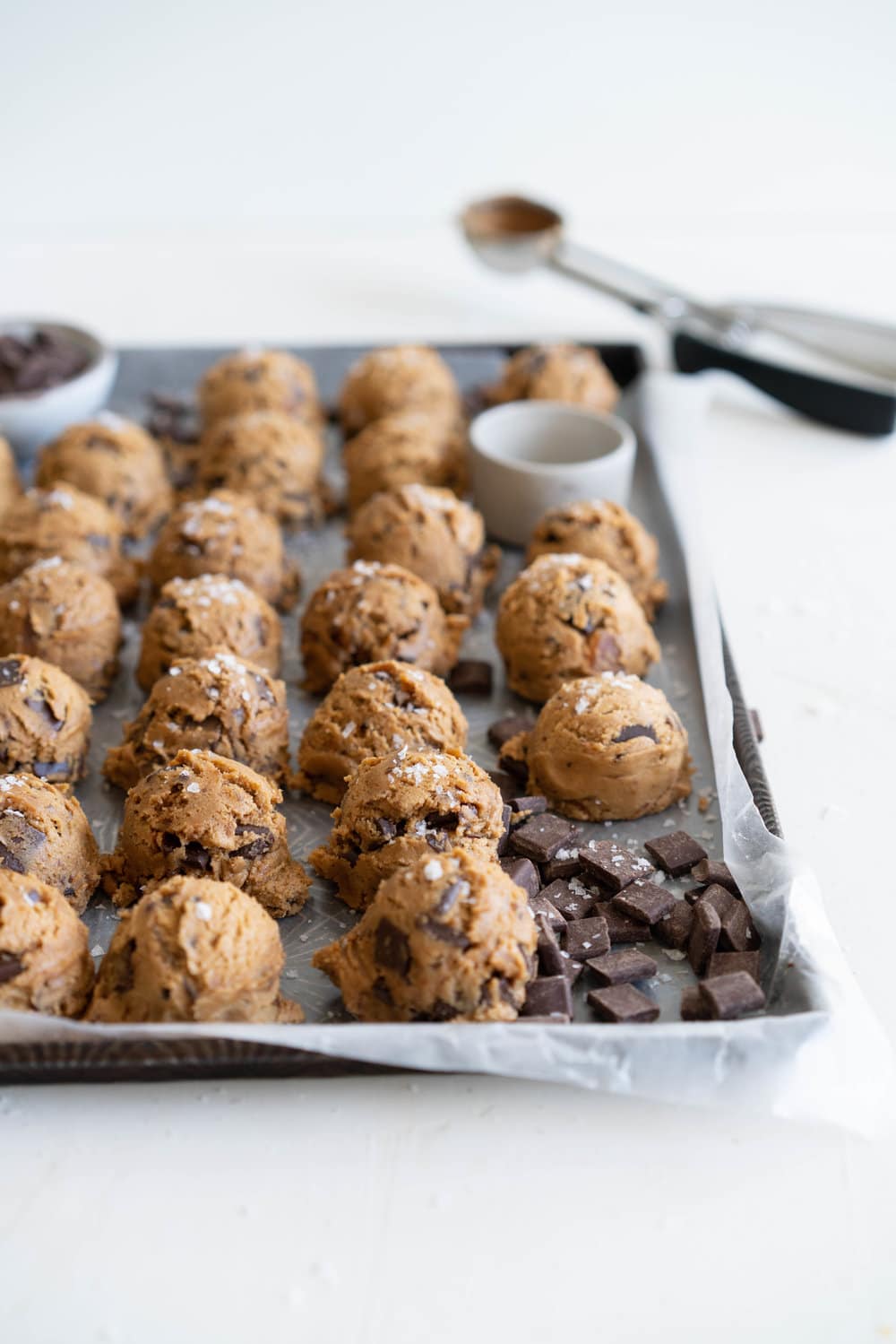 Brown Butter Salted Caramel Chocolate Chunk Cookies. Regular pantry staples are elevated to another level to give this cookie a 'fancy with only a little more effort' vibe. Brown butter is stirred in with toasty muscovado sugar to form a perfect cookie dough, and then hard caramel shards and chocolate chunks are folded in to give the perfect amount of chocolate and caramel per bite. Finished with flaky sea salt, this is a super easy yet satisfying baking recipe. #saltedcaramelcookie #chocolatechunkcookie #brownbutter