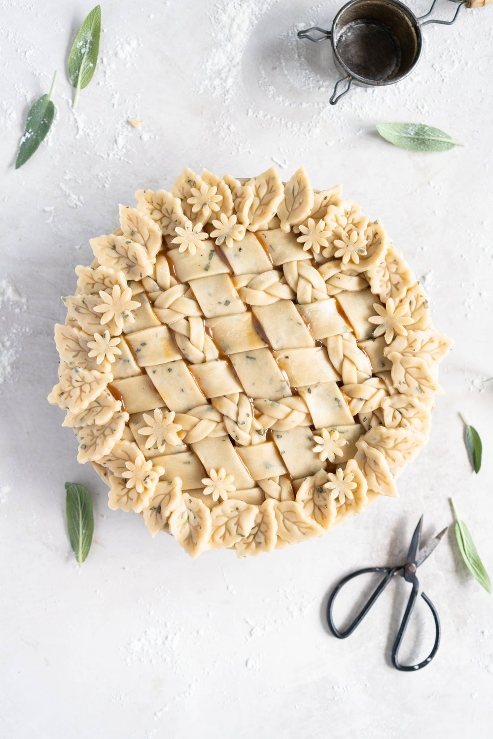 Sage Salted Caramel Apple Pie with Fresh Sage Crust - Flaky pie dough flecked with fresh sage holds an apple filling, topped with a sage salted caramel. A perfect twist on the classic salted caramel apple pie.