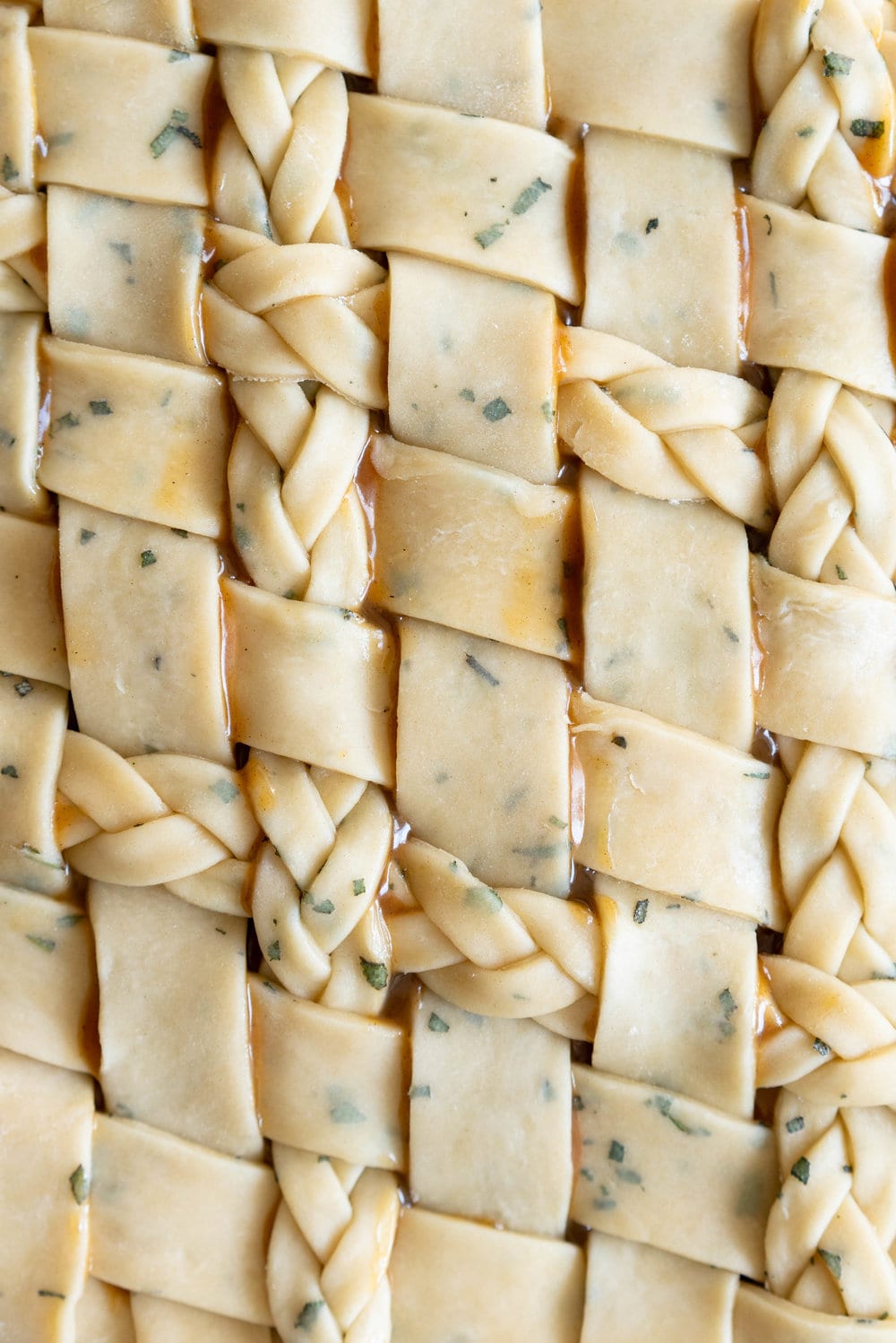 Sage Salted Caramel Apple Pie with Fresh Sage Crust - Flaky pie dough flecked with fresh sage holds an apple filling, topped with a sage salted caramel. A perfect twist on the classic salted caramel apple pie.