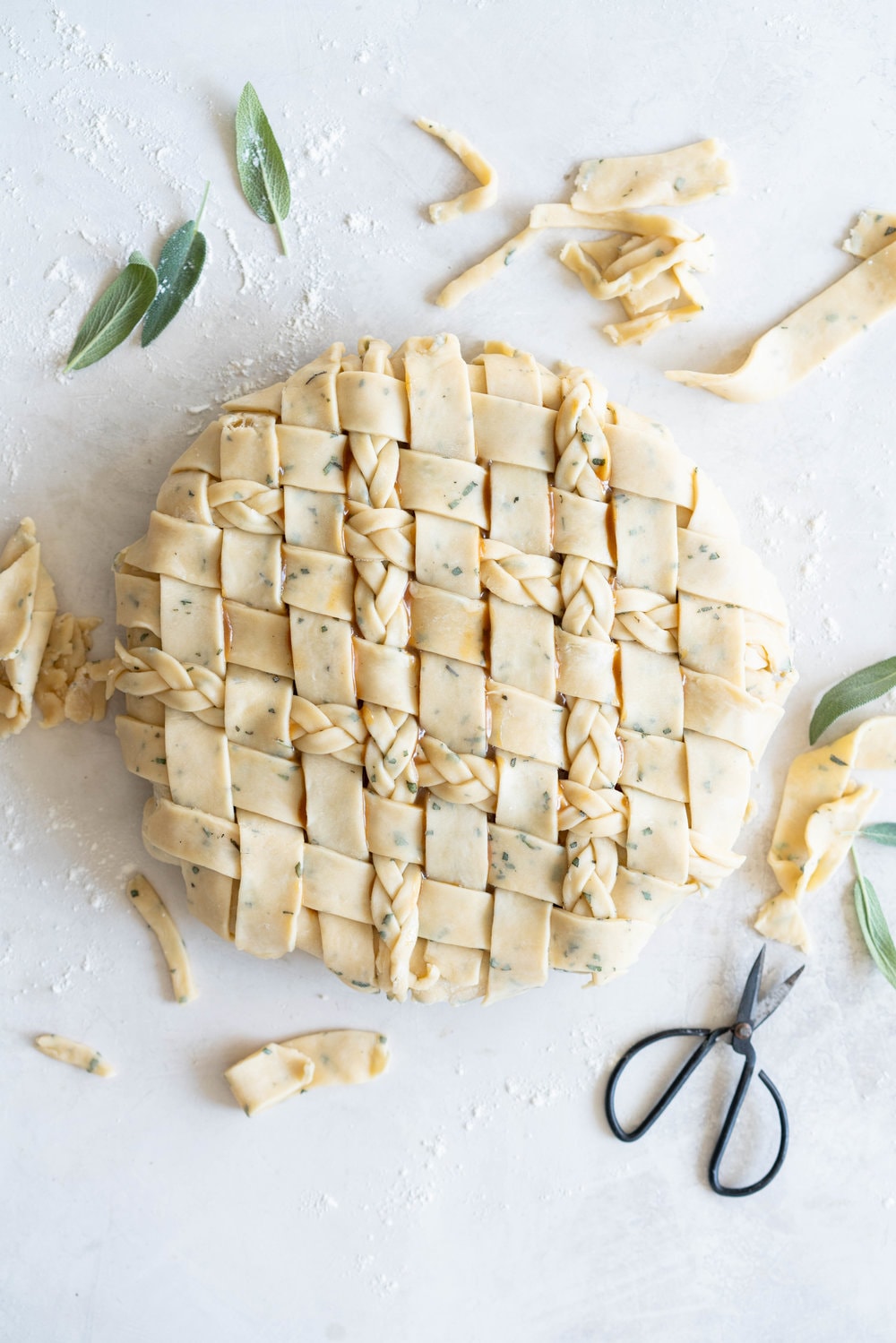 Sage Salted Caramel Apple Pie with Fresh Sage Crust - Flaky pie dough flecked with fresh sage holds an apple filling, topped with a sage salted caramel. A perfect twist on the classic salted caramel apple pie.
