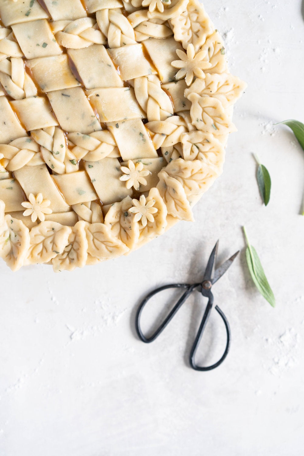 Sage Salted Caramel Apple Pie with Fresh Sage Crust - Flaky pie dough flecked with fresh sage holds an apple filling, topped with a sage salted caramel. A perfect twist on the classic salted caramel apple pie.