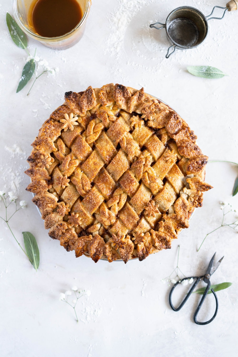 Sage Salted Caramel Apple Pie with Fresh Sage Crust - Flaky pie dough flecked with fresh sage holds an apple filling, topped with a sage salted caramel. A perfect twist on the classic salted caramel apple pie.