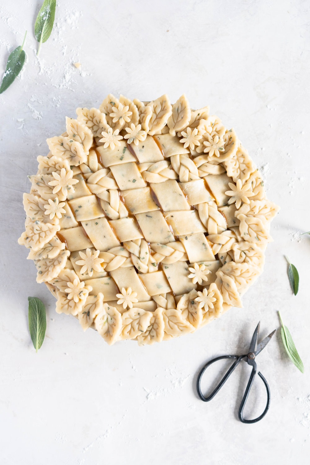 Sage Salted Caramel Apple Pie with Fresh Sage Crust - Flaky pie dough flecked with fresh sage holds an apple filling, topped with a sage salted caramel. A perfect twist on the classic salted caramel apple pie.