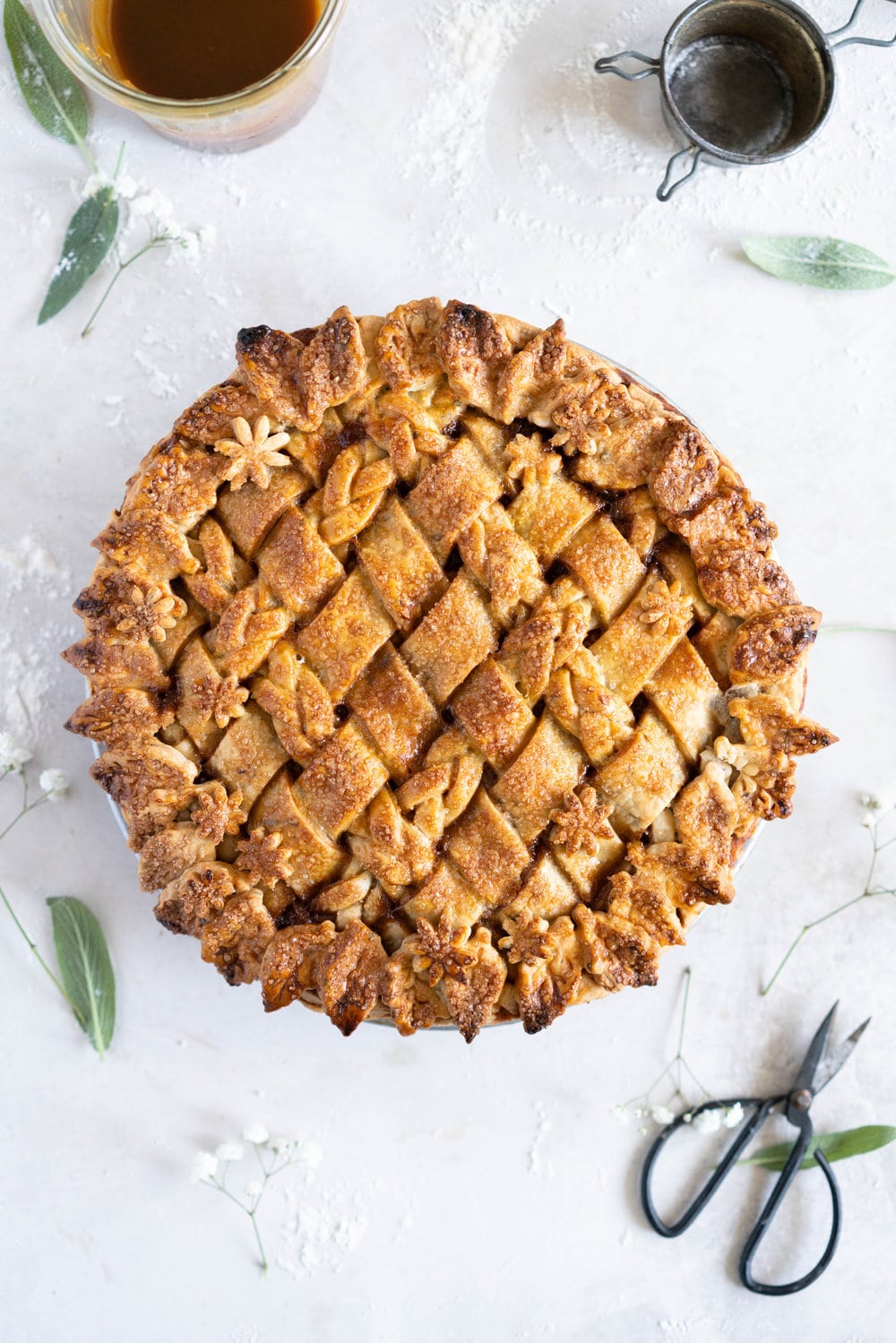 Sage Salted Caramel Apple Pie with Fresh Sage Crust - Flaky pie dough flecked with fresh sage holds an apple filling, topped with a sage salted caramel. A perfect twist on the classic salted caramel apple pie.