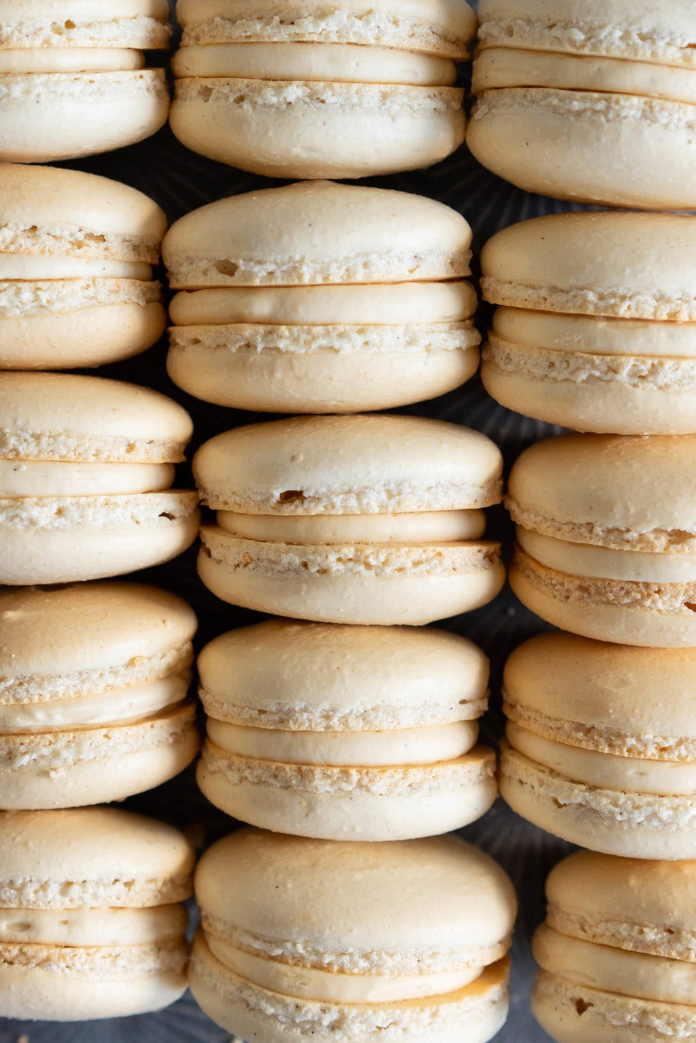 Toasted Sugar Vanilla Bean Macaron shells are sandwiched with a silky, creamy German buttercream loaded with caramelised white chocolate, Subtle elevated flavours makes this a perfect simple recipe that is sure to wow your friends or make the perfect treat or gift. #frenchmacaron #macaronrecipe