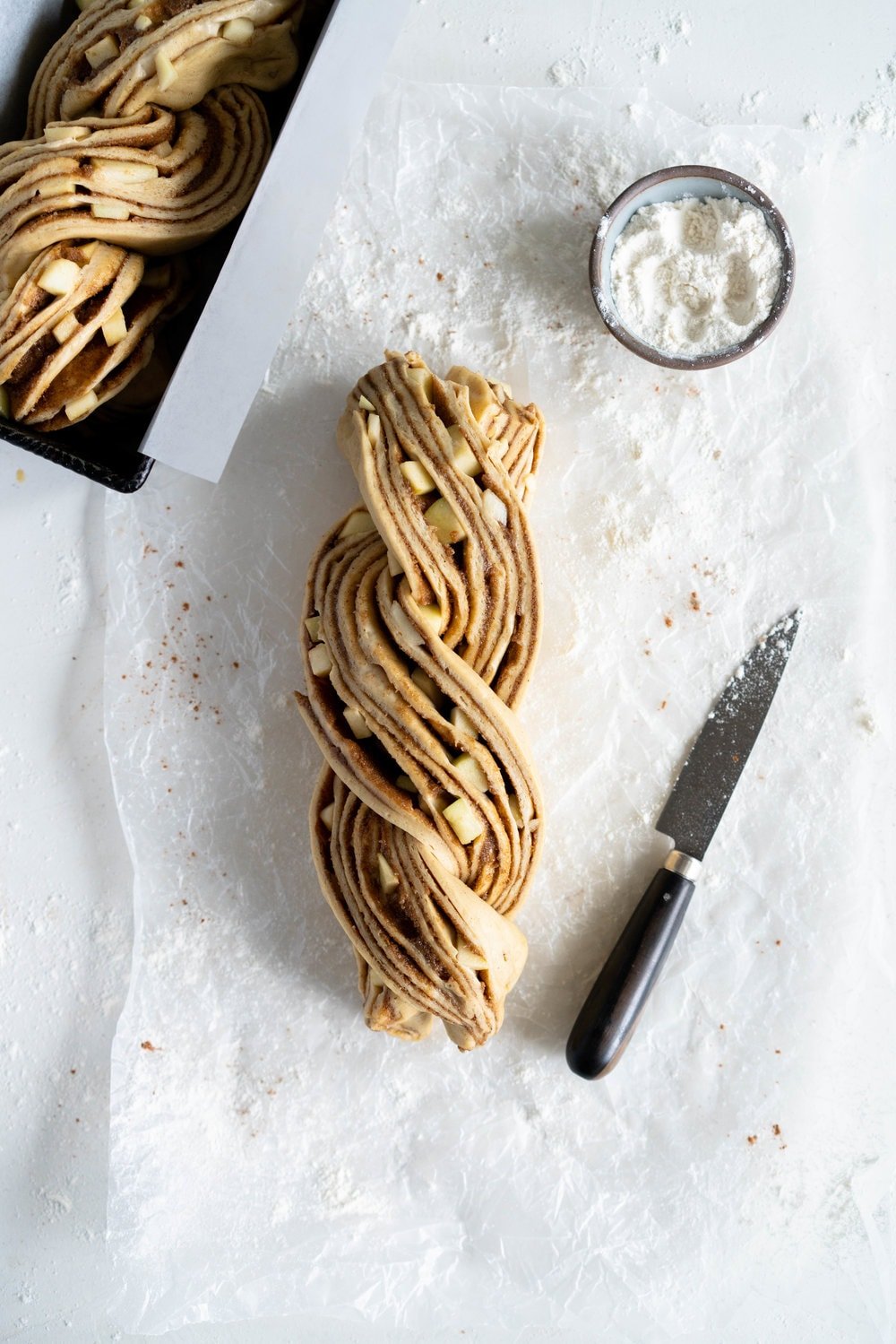 Apple and Cardamom brioche babka - lightly spiced babka dough is filled with a spiced brown sugar mixture and fresh apple, then rolled into a tight babka swirl. Inspired by the swedish cinnamon roll, this is a perfect fall baking project. #babka #cardamom #brioche