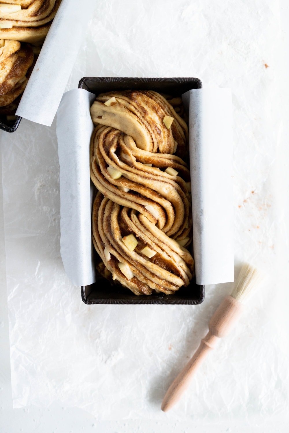 Apple and Cardamom brioche babka - lightly spiced babka dough is filled with a spiced brown sugar mixture and fresh apple, then rolled into a tight babka swirl. Inspired by the swedish cinnamon roll, this is a perfect fall baking project. #babka #cardamom #brioche