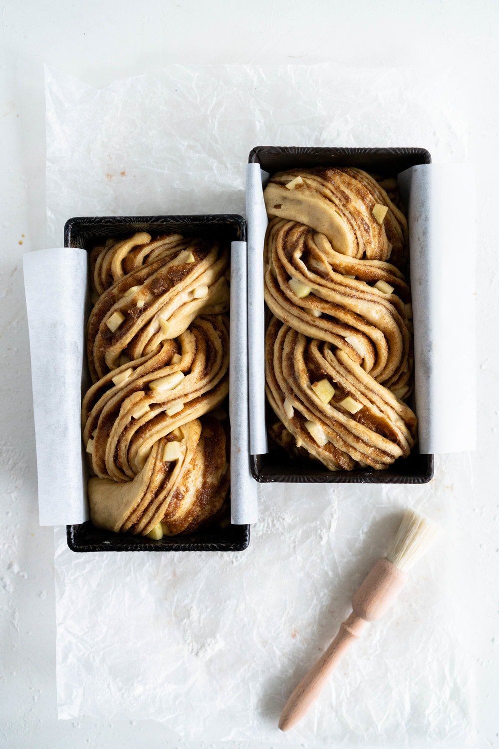 Apple and Cardamom brioche babka - lightly spiced babka dough is filled with a spiced brown sugar mixture and fresh apple, then rolled into a tight babka swirl. Inspired by the swedish cinnamon roll, this is a perfect fall baking project. #babka #cardamom #brioche